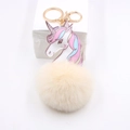 Unicorn plush ball keychain with colorful gradient mane and cream faux fur charm - Off-white