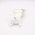 Detail of white plush monster keychain with spring legs and silver metal lobster clasp - White