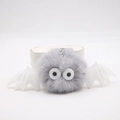 Detail of grey plush monster keychain with white bat wings and silver metal chain - Light Gray