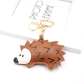 Macro detail of brown PU leather hedgehog keychain with fine stitching and golden clasp - Brown
