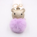 Detail of golden crown bear keychain with large purple fluffy plush pompom accessory - Taro Purple