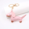 Portachiavi a forma di bassotto in pelle PU rosa con moschettone dorato su supporto - Rosa