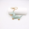 Detail of light green PU leather dachshund keychain with white stitching and gold hardware - Matcha Green