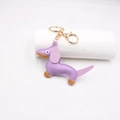 Detailed macro view of purple leather dachshund keychain with golden lobster clasp - Taro Purple