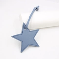 Detail of blue star-shaped PU leather bag charm with high-quality litchi texture and stitching - Star Lanyard / Blue