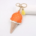 Detail of creative ice cream leather keychain with white cross-stitched cone and gold clasp - Orange