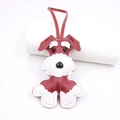 Detailed close-up of handmade leather Schnauzer bag charm with white contrast stitching - Burgundy
