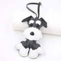 Handmade leather Schnauzer bag charm with white stitching and black lanyard on white - Black
