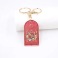 Detail van rode PU-leren sleutelhanger met goudkleurige hardware en reliëf embleem - Rode Adelaar