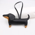 Detailed close-up of a handmade black and tan leather dachshund bag charm with stitching - New Dachshund Style / Black