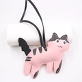 Pink and black cartoon cat leather bag charm with sleek hanging strap on white background - Pink