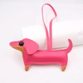 Detail view of pink dachshund leather bag charm with brown accents and stitching - New Dachshund Style / Rose Red