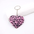 Detailed view of pink leopard print plush heart keychain with silver metal ring - Rose Red