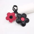 Close-up of litchi pattern leather cherry blossom charms with detailed stitching - Black Rose