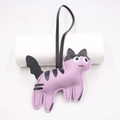 Detail view of purple leather cat charm with black stripes and white stitched edges - Taro Purple