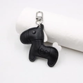 Détail d'un pendentif cheval en cuir noir à grain de litchi avec motifs de cœur gravés - Pendentif en Forme de Cheval / Noir