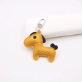 Macro detail of ginger leather horse keychain with heart embossing and silver clasp - Horse Shape Pendant / Yellow and Black
