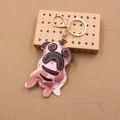 Detailed macro view of pink camo leather pug keychain with golden metal clasp - Pink