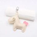 Détail d'un porte-clés poney en cuir beige avec signe dollar en cristal et fermoir - Beige
