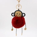 Detail of creative monkey plush keychain with soft faux fur ball and gold lobster clasp - 8cm / Burgundy