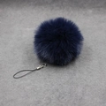 Macro detail of a navy blue fluffy faux fur ball keychain with silver lobster clasp hook - 8cm Faux Fur + Strap / Navy Blue