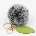 Detail of grey faux fur pompom keychain with golden ring and green textured leaf charm - Two-tone Black
