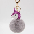 Detailed close-up of a unicorn keychain with purple glitter mane and fluffy grey pompom charm - Gray