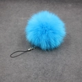 Detail of bright blue faux fur ball keychain with silver lobster clasp and black lanyard - 8cm Faux Fur + Strap / Lake Blue