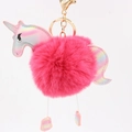 Close-up of fluffy pink unicorn pom pom keychain with holographic metallic details - Rose Red