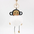 Détail du porte-clés singe avec pompon en fausse fourrure blanche et fermoir doré chic - Blanc