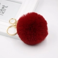 Detail of soft burgundy faux fur pompom keychain with golden metal clasp for bags - Burgundy