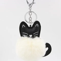 Detail of a black leather cat charm with a fluffy cream pompom and silver metal clasp - 8cm Faux Rabbit Fur / Off White