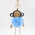 Close-up of blue plush monkey keychain with fluffy fur ball and gold lobster clasp - 8cm / Light Blue