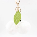 Close-up of white plush cherry keychain with green leather leaves and gold hardware - 8cm Faux Rabbit Fur / White