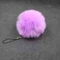 Detail of a fluffy purple faux fur pom-pom keychain with silver lobster clasp and strap - 8cm Faux Fur + Strap / Light Purple