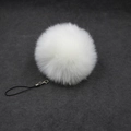 Detail of white faux fur pompom keychain with soft texture and metallic lobster clasp - 8cm Faux Fur + Strap / White