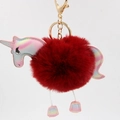 Close-up of fluffy dark red faux fur unicorn keychain with gold metal spring clasp - Burgundy