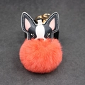 Detail von süßem Welpen-Fell-Schlüsselanhänger mit orangefarbenem Bommel und Goldclip - 8cm / Orangerot