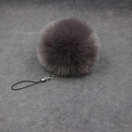 Detail of dark purple plush faux fur pompom with silver lobster clasp and black lanyard - 8cm Faux Fur + Strap / Dark Gray