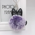 Detailed view of purple faux fur pompom cat keychain with black PU leather head and silver clasp - 8cm Faux Rabbit Fur / Two-tone Purple