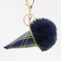 Macro detail of dark blue faux fur ice cream keychain with golden alloy lobster clasp - Navy Blue