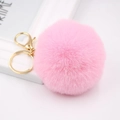 Close-up of soft pink faux fur pompom with bright gold metal lobster clasp and keyring - Deep Pink