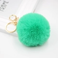 Detail of soft mint green faux fur pompom keychain with polished gold lobster clasp - Grass Green