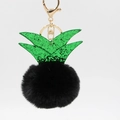 Detail of pineapple plush keychain with black faux fur ball and green sequin leaves - Black