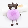 Close-up of a brown leather bear keychain with fluffy purple faux fur ball and gold clasp - Taro Purple