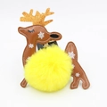 Detail of Christmas reindeer keychain featuring yellow pom pom and gold glitter antlers - Yellow