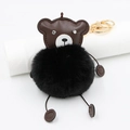 Detail of plush black fur ball and brown leather bear keychain with golden clasp - Black