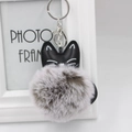 Close-up of a black PU leather cat charm with a fluffy gray faux fur pompom keychain - 8cm Faux Rabbit Fur / Two-tone Grey