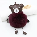 Detail view of burgundy faux fur bear keychain with sparkling diamond eyes and gold clasp - Fuschia