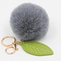 Detail of grey faux fur pom pom keychain with green leaf charm and gold metal clasp - Medium Grey